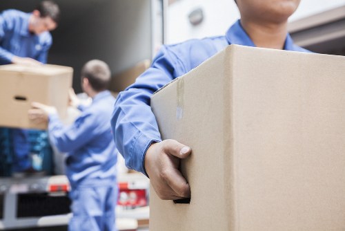 Removal team planning a London home move with boxes and furniture