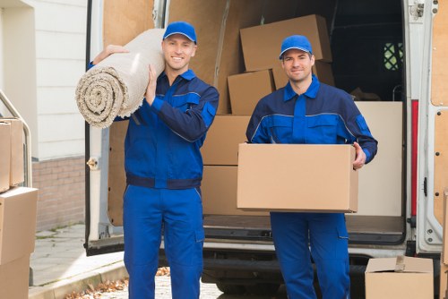 Professional removals team loading boxes into a van