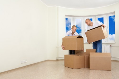 Local moving team handling boxes and furniture in a London street