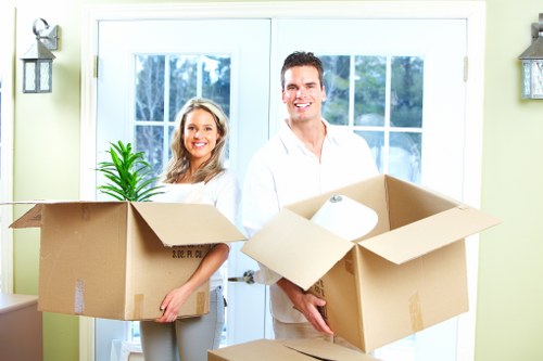 Professional movers loading household items into a removal van